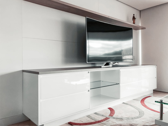A white entertainment center with a flat screen tv on top.