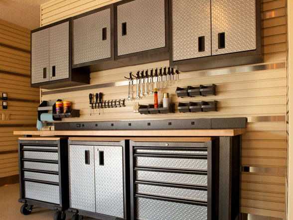 A garage with cabinets and drawers on the wall.