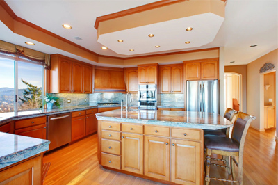A kitchen with wooden cabinets and stainless steel appliances.
